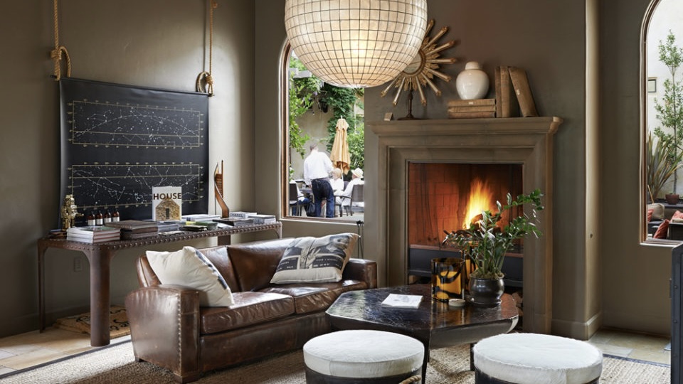 North Block Hotel, Yountville one of the best boutique hotels in Napa Valley roaring fireplace and people at table